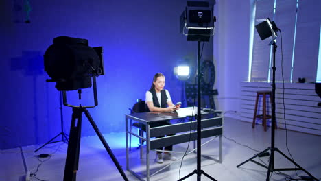 creating a video studio. a content creator prepares for a recording session in a well-lit studio with multiple cameras and lighting setups