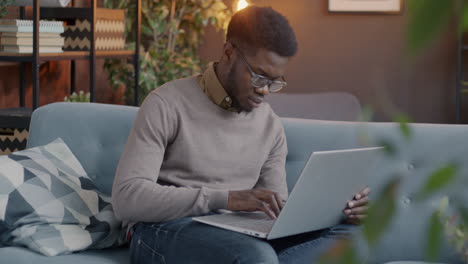 hombre trabajando en una computadora portátil en casa
