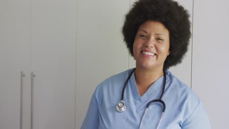 video of happy plus size african american female doctor looking at camera
