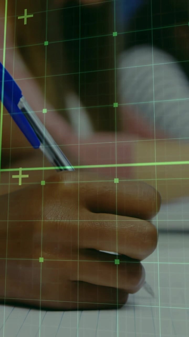 Vertical video: Right hand resting on paper pen hovering tapping knuckle activating green tech grid