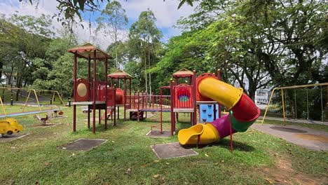 a vibrant public playground for children in a beautiful tropical park. sunny weather enhances the cheerful outdoor atmosphere