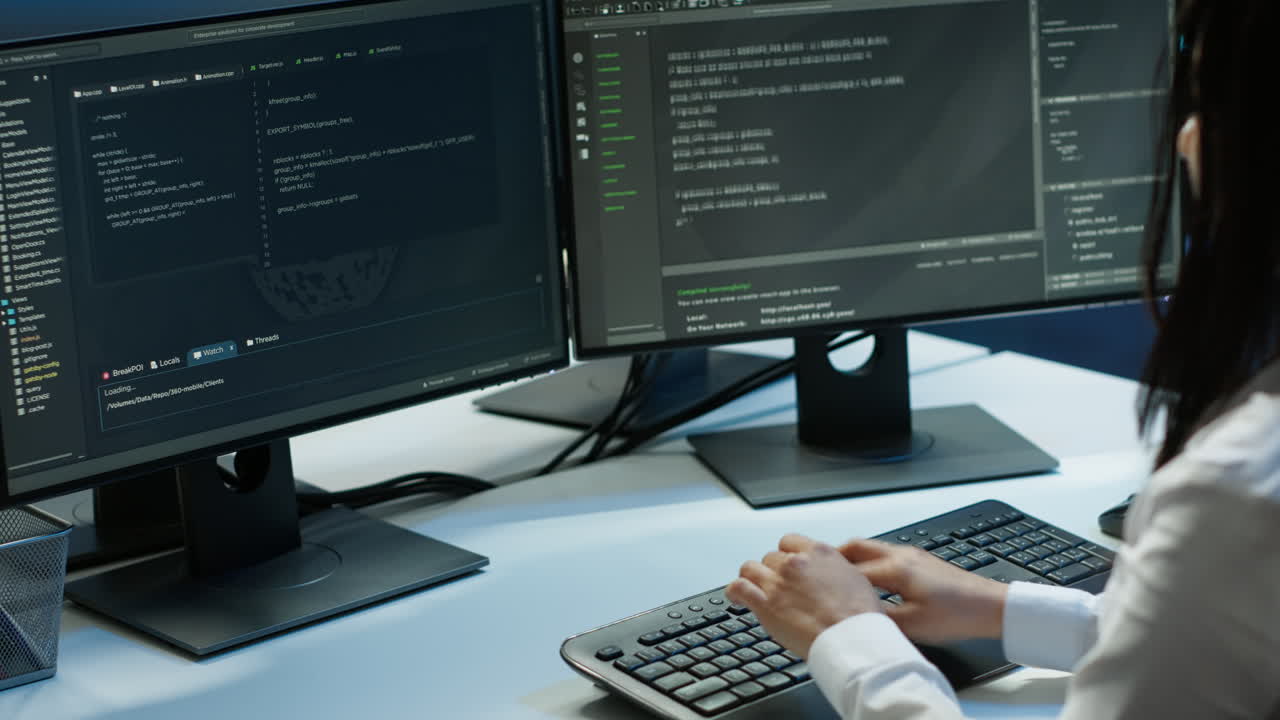 Computer scientist in data center monitoring security threats using computer