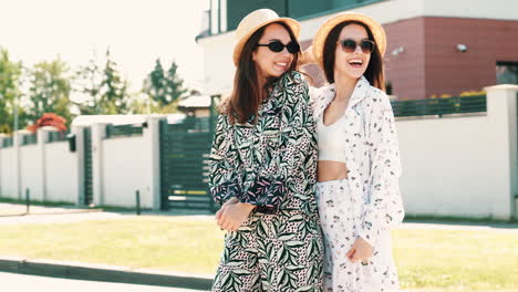 two happy women posing outdoors