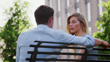 businessman talking to female colleague on break in park