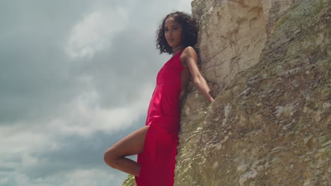 a girl wearing a striking red dress enjoys the view from san fernando hill, where the city and coastline meet.