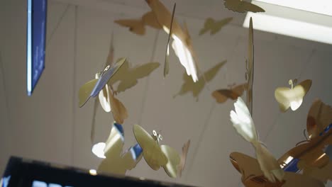 beautiful golden butterflies hang on strings decorating the room giving a festive atmosphere