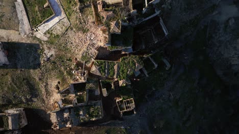 Top-down-drone-dolley-shot-of-the-derelicted-ghost-town-Craco-on-a-sunny-day