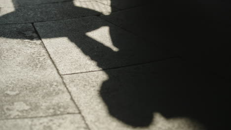 shadows of a chestnut seller placing chestnuts on oven in slow motion