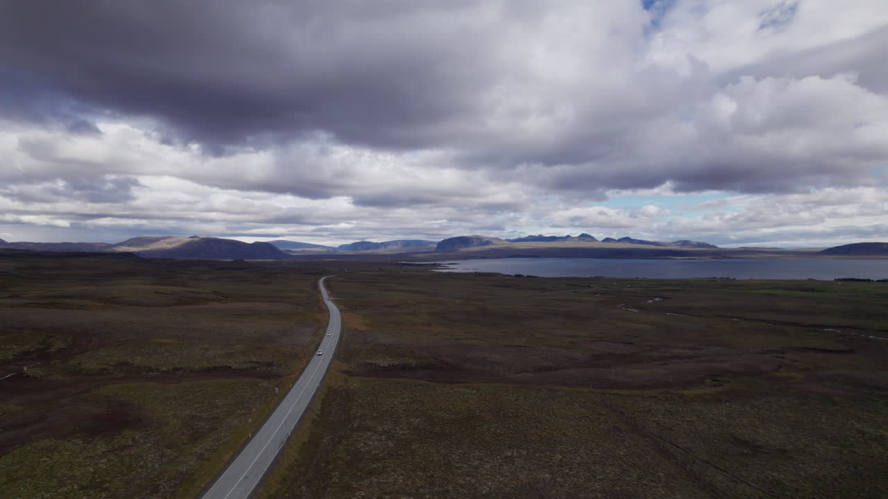 An empty highway and Thingvallavatn Lake near Thingvellir National Park in Central Iceland, Aerial View