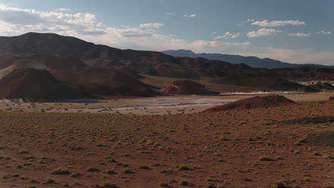 Drone-Aéreo-Vuela-A-Través-Del-Desierto-De-Nevada-Mientras-Un-Camión-4x4-Conduce-En-La-Distancia