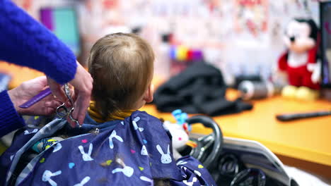 baby getting a haircut at a hair salon