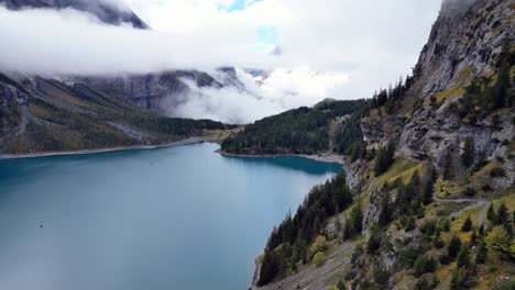 drone shots of öschinensee near kandersteg in switzerland with turquoise water in direction of kandersteg