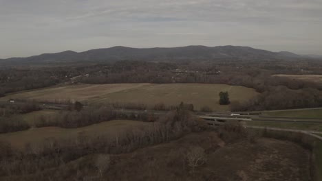 A-beautiful-landscape-with-mountains-in-the-background-of-a-highway-with-light-traffic-in-a-rural-area