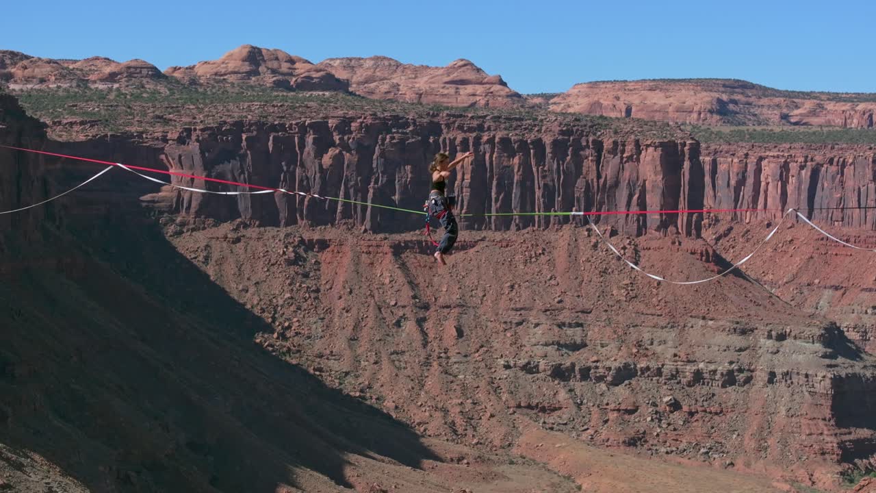 Woman highlining in Moab, USA, showcasing thrill of balance and nature