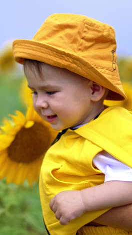 Baby in a Yellow Outfit in a Sunflower Field