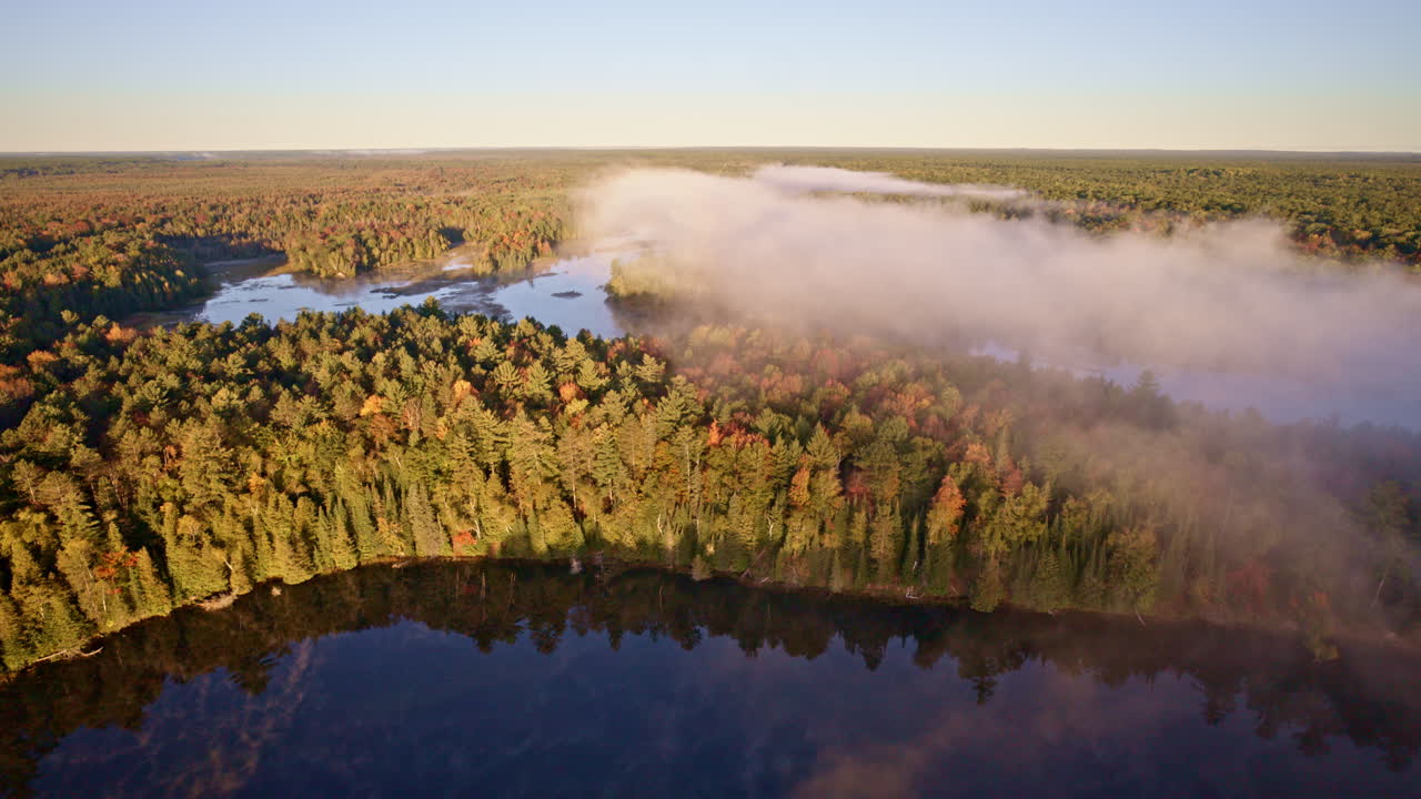 Aerial shot showing soft vapor rising from the water at dawn
