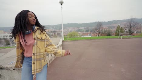 cheerful woman listening to music and dancing freestyle