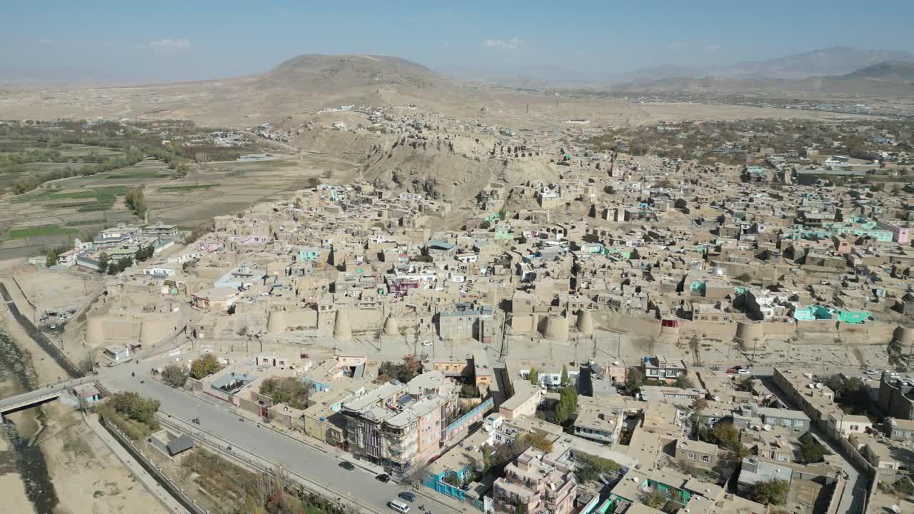 Ghazni, Afghanistan. Drone Aerial View of Historic Citadel, Street Traffic, City Buildings and Homes