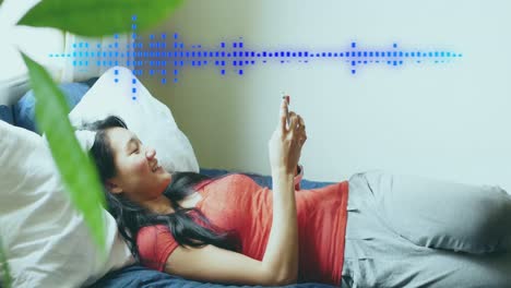 animation of data processing over happy asian woman using smartphone