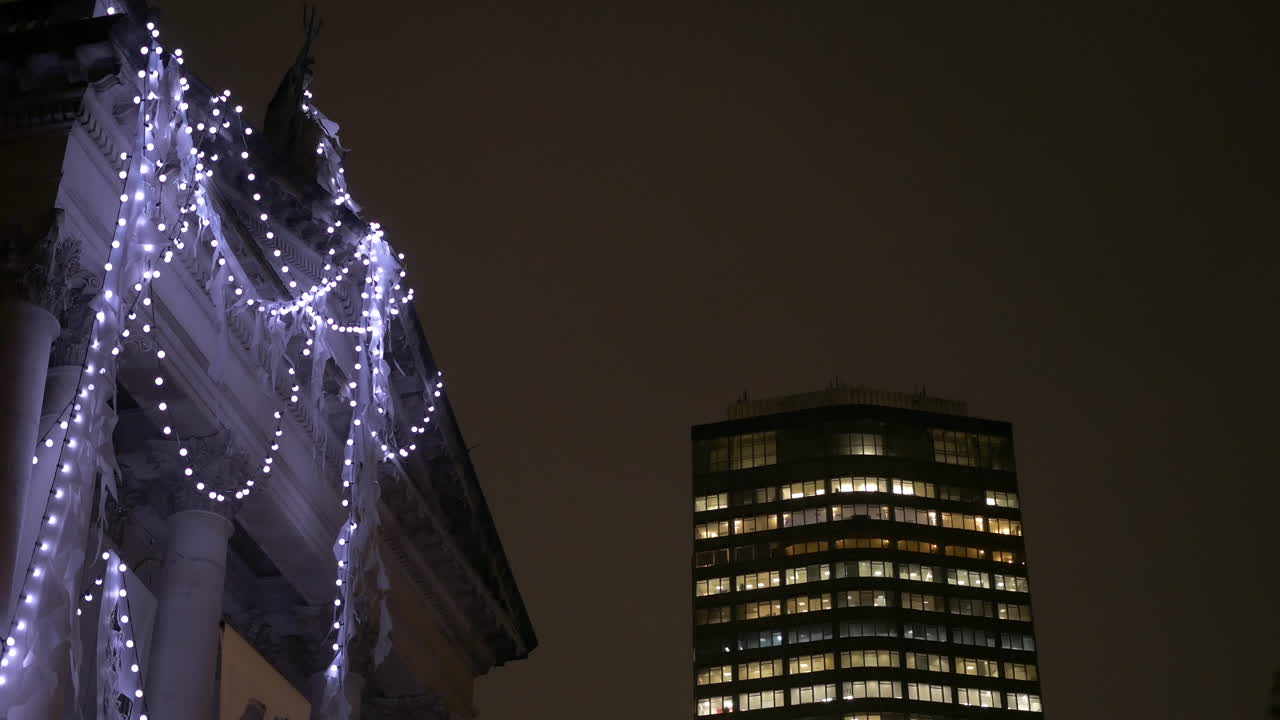 Strand of Christmas lights hang on the facade of a historic art museum in London UK