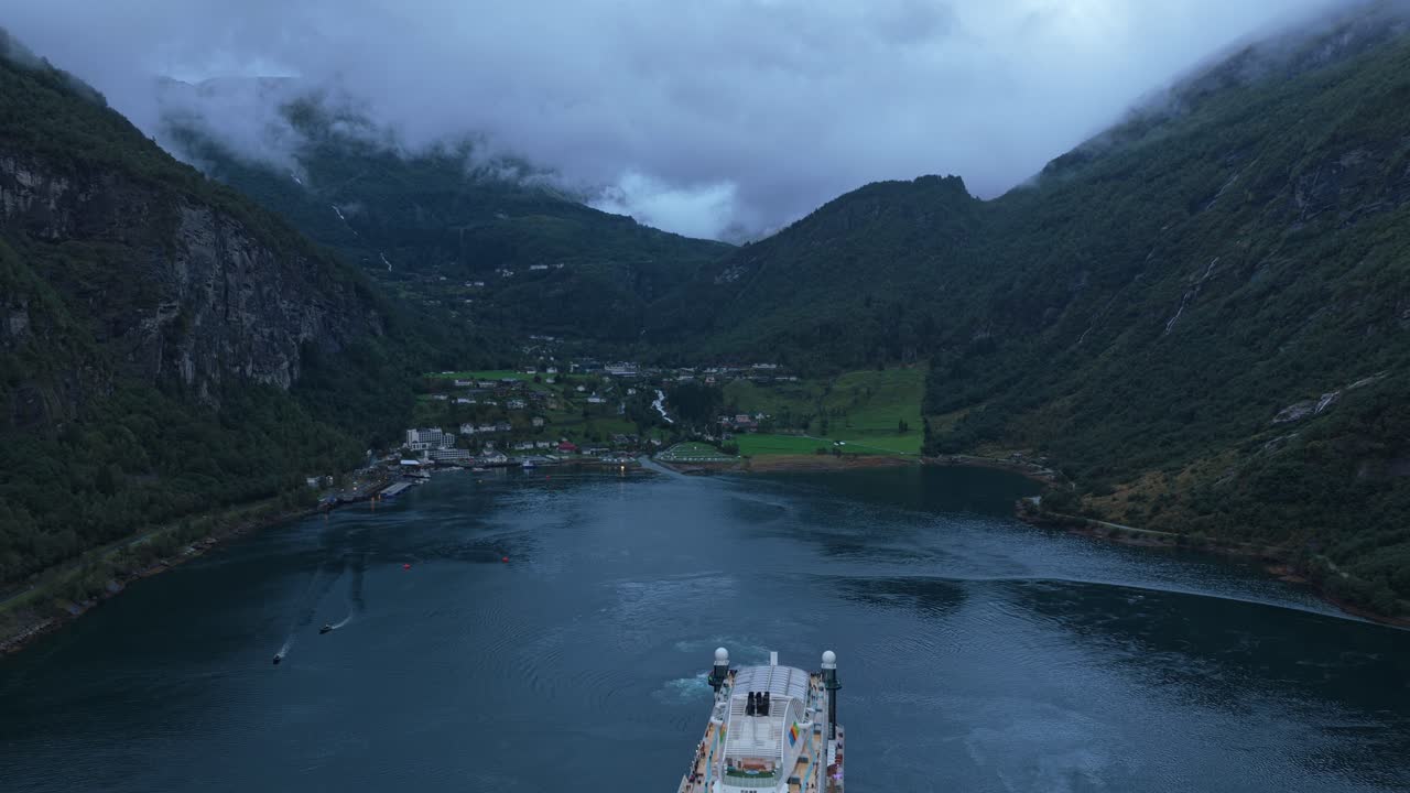 Departure of cruise liner through Geirangerfjord, seen from above