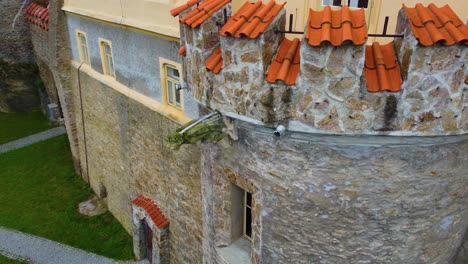 stone walls of castle building in czech republic, close up aerial flying