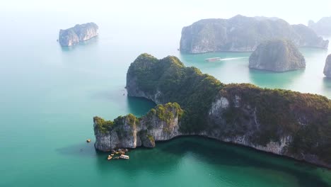 aerial drone shot over ha long bay, blue sea and limestone islands of lan ha bay