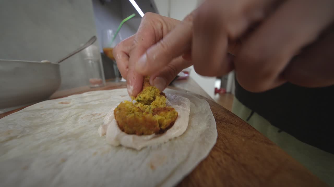 Preparazione di un wrap di falafel