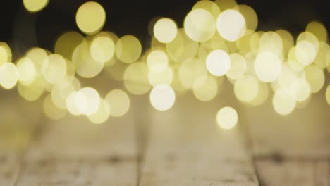 video of close up of christmas fairy lights on wooden background