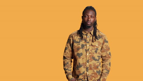 Portrait-of-man-with-braids-smiling-in-front-of-camera