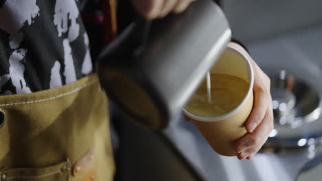 barista pouring latte
