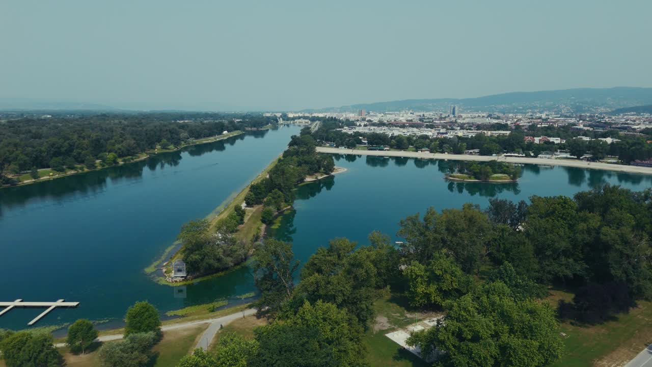 deep blue waters of Lake Jarun reflect trees and cityscape west of central Zagreb