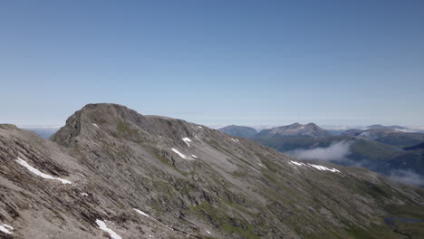 Clear-rocky-mountain-slope-of-Romsdalen,-Norway-on-a-sunny-day--Aerial