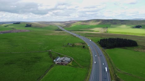 motorway running through countryside in cumbria, hills in distance