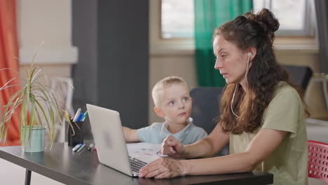 mother and son doing online education at home