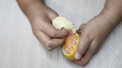 sequential frames showing the peeling of an orange