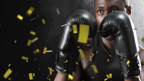 animation of confetti falling over african american male boxer on black background