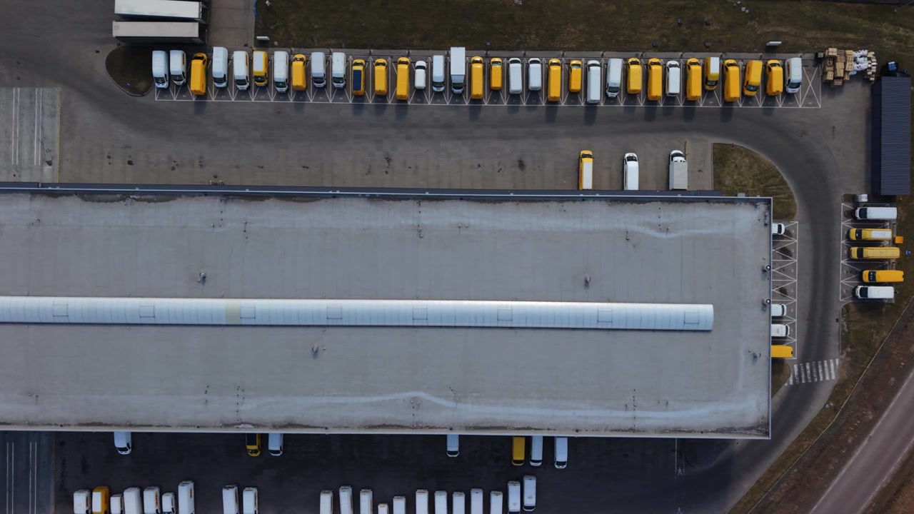 Drone Aerial Fulfillment Center Loading Dock With Dock Doors And Queued Trailers, Warehouse Crew Moving Pallets, Loading Bays, Dispatch Signage, Efficient Order Processing For Ecommerce