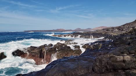 slow motion video of a wave crashing on the coast of lanzarote