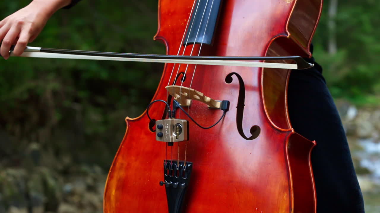 Performance music on nature. Woman performing music on violin on mountain outdoor