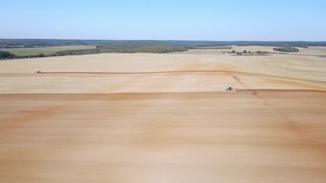 an aerial view of a tractor working on a large agricultural field