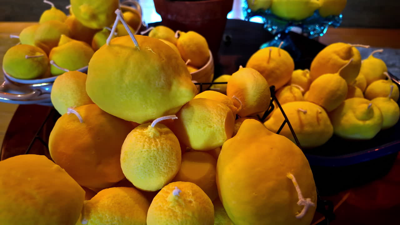 Candles shaped like lemons glow warmly in a basket, creating a festive atmosphere