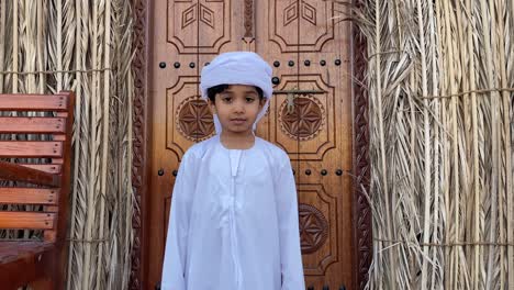 an emirati kid  in arabic traditional background