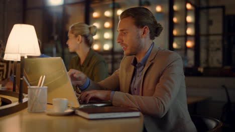 boss using laptop on meeting with team. creative colleagues discussing business.