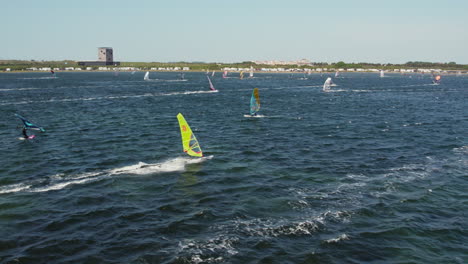 tourists wind surfing over grevelingen lake near port zelande, zeeland, the netherlands