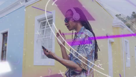 animation of round scanner and light trails over african american man using a smartphone on street