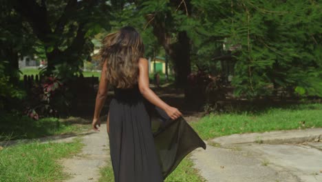 a girl wearing a black dress embraces the serene beauty of the river.