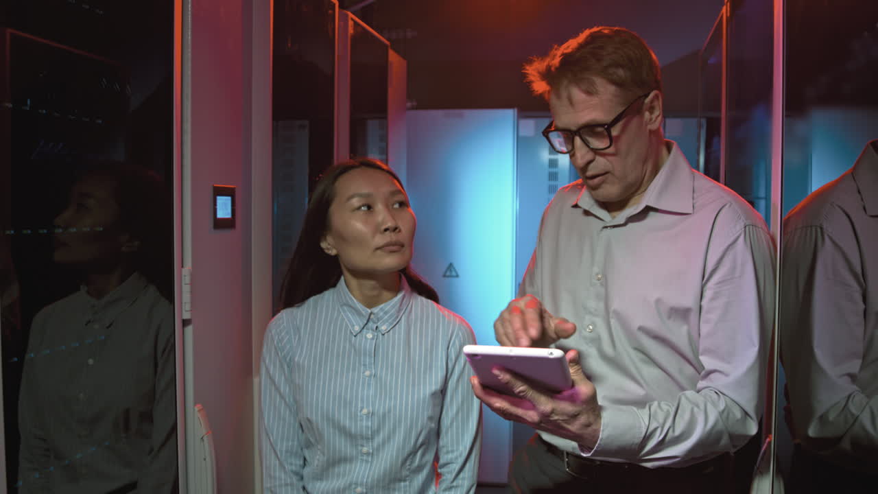 Colleagues Walking Through Data Center and Talking