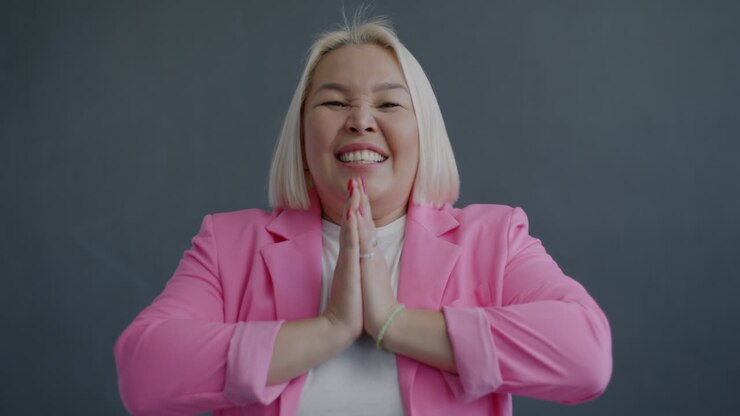 Donna con blazer rosa che prega