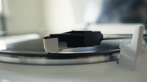 record player arm needle drop and needle close-up while playing vinyl